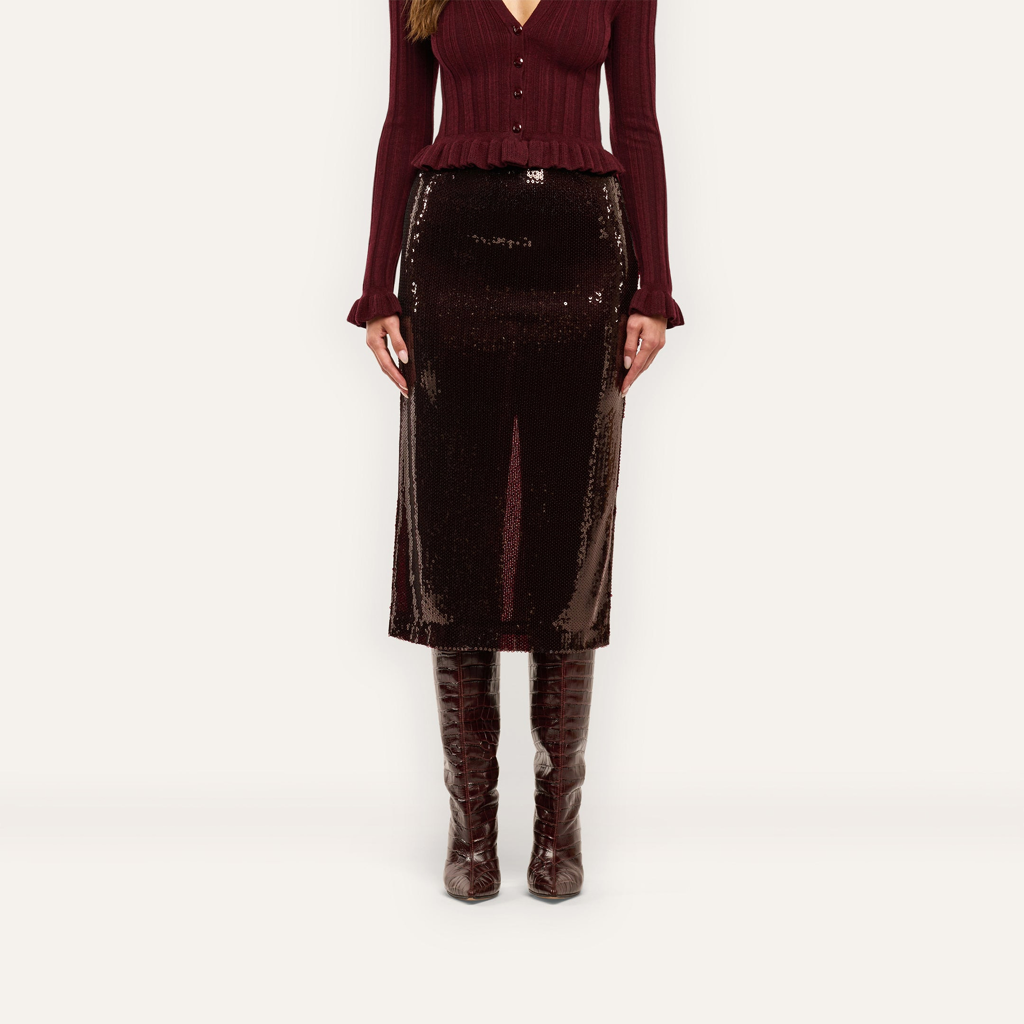 A Makena Sequin Pencil Skirt in espresso brown worn with a matching ribbed cardigan and knee-high boots, reaching below the knees.