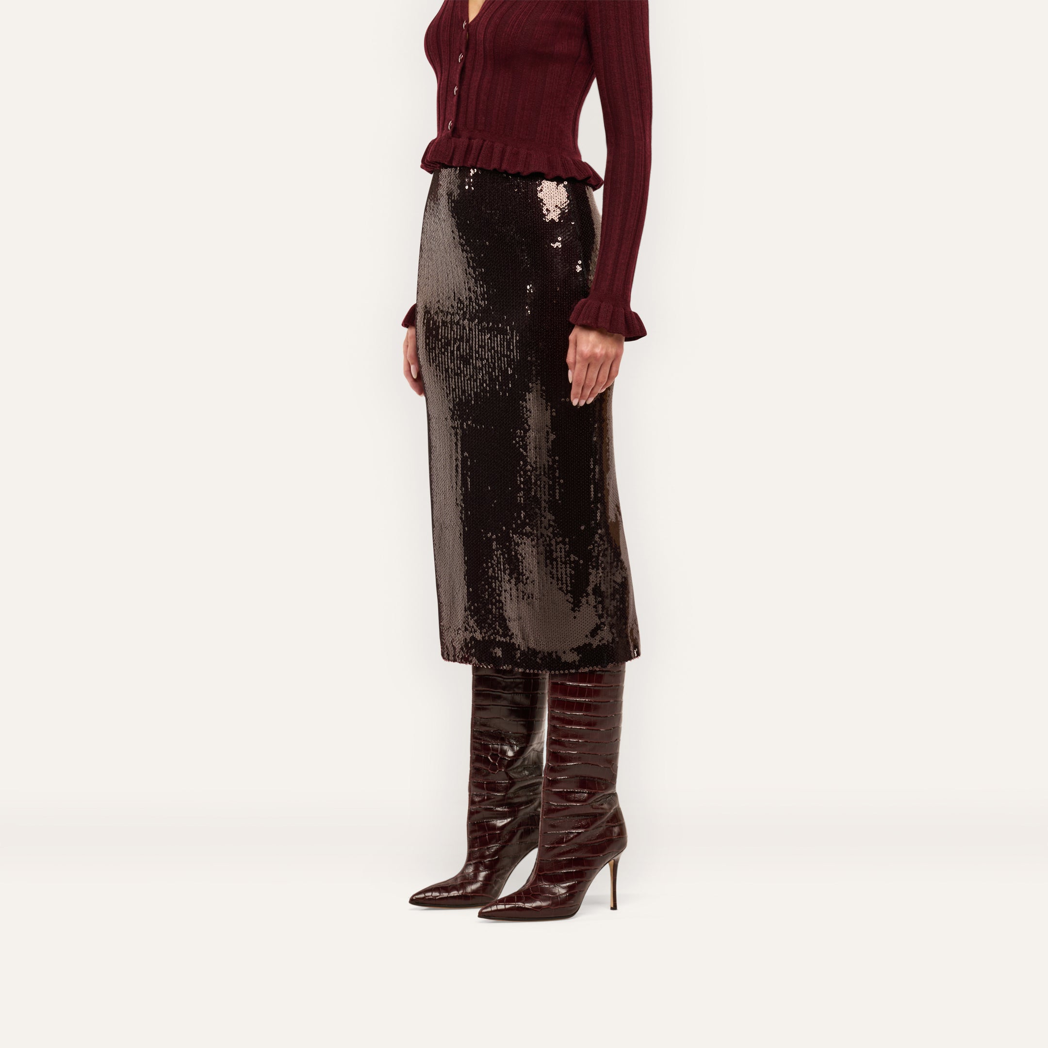 A Makena Sequin Pencil Skirt in espresso brown paired with a burgundy ribbed cardigan and tall, pointed-toe stiletto boots.