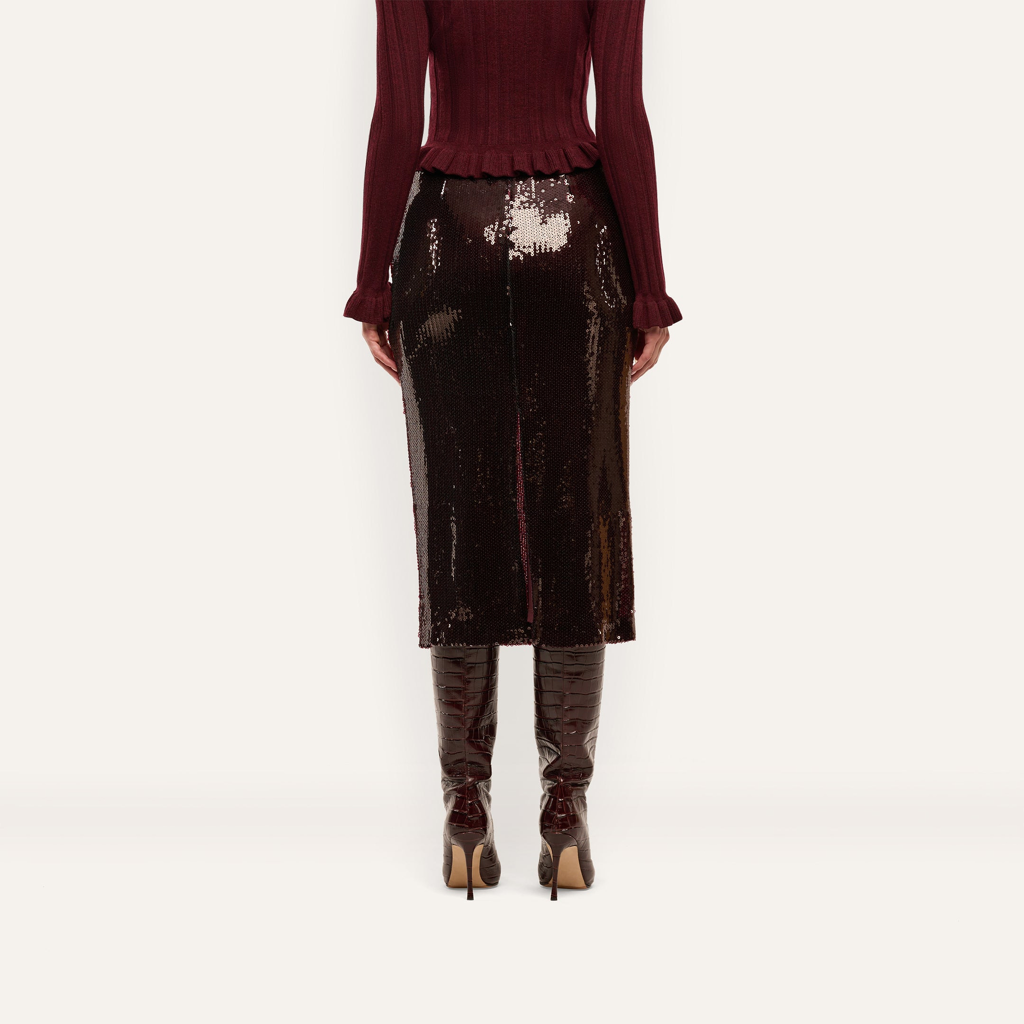 An espresso brown, sequined Makena Sequin Pencil Skirt worn with a matching sweater and heeled boots.
