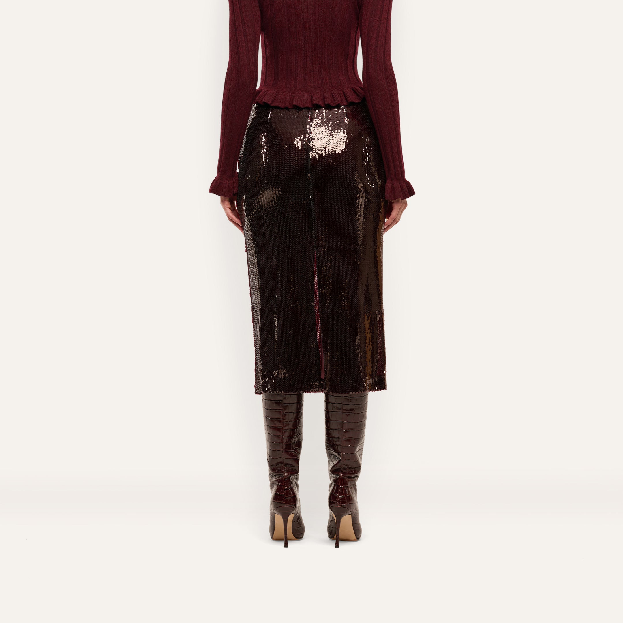 An espresso brown, sequined Makena Sequin Pencil Skirt worn with a matching sweater and heeled boots.
