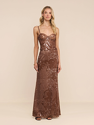 A woman wearing the Zeta Sequin Maxi Skirt with thin straps, standing against a plain white background.