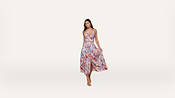 Woman wearing a colorful, floral-patterned, sleeveless crop top and matching high-waisted, flowy midi skirt with a slit, posing against a plain white background. She is wearing strappy heels.