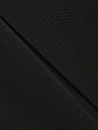 Close-up of black fabric with a diagonal fold, showing fine texture and subtle weave pattern—ideal for the Tania Pleated Mini Skirt.