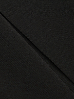 Close-up of black stretch fabric with a smooth, slightly textured surface and diagonal fold, creating subtle shadows—perfect for the Tania Pleated Mini Skirt’s modern prep style.