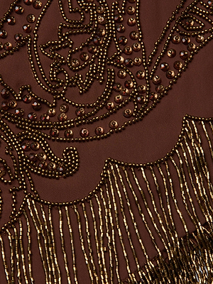 Close-up of intricate bead and sequin embroidery on brown fabric with gold accents and fringe, highlighting the decorative texture and 1920s-inspired elegance of the Eulla Embellished Mini Skirt by L'AGENCE Sale.