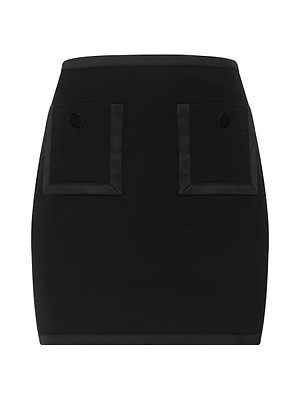 The Cassiopeia Mini Skirt is a black mini skirt made from stretch suit fabric, featuring two front patch pockets with flaps and black buttons, shown against a white background.