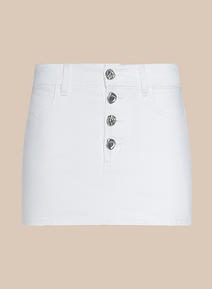 The Solene Jean Mini Skirt is a white denim mini skirt with belt loops, two front pockets, and a front closure featuring four visible novelty buttons, shown against a beige background.