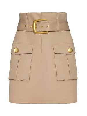 The Maelis Mini Skirt is a beige paperbag mini skirt with a high-rise waist, wide belt and large gold buckle, plus two front cargo pockets embellished with gold buttons.