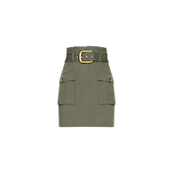 The Maelis Mini Skirt is an olive green paperbag mini skirt featuring a wide belt with a gold buckle and two front cargo pockets with buttons, displayed against a plain white background.