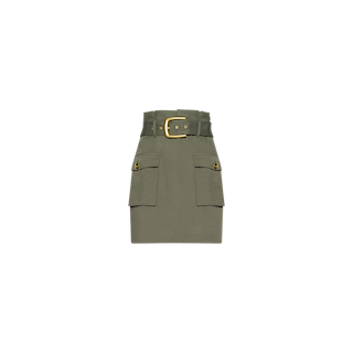 The Maelis Mini Skirt in smokey olive green features large cargo pockets, button accents, and a wide matching belt with a gold buckle, showcased against a plain white background.