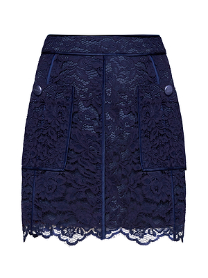 The Riven Lace Mini Skirt is a midnight blue A-line mini with a floral lace overlay, front pockets, button details, and a scalloped hemline. Its fitted waistband creates a chic, feminine look.
