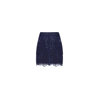 The Riven Lace Mini Skirt, shown in navy blue against a white background, features delicate lace detailing, front buttons, two front pockets, and a scalloped hem. This elegant A-line skirt effortlessly blends classic style with modern sophistication.