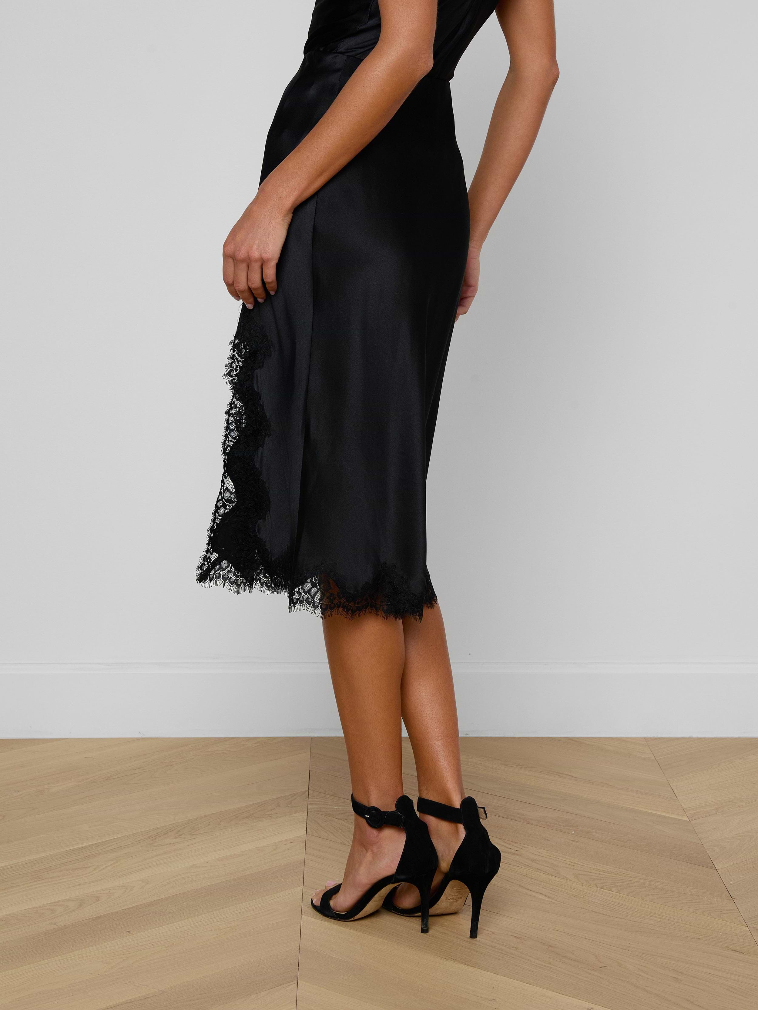 A person wearing the Tico Silk Lace Skirt and black high-heeled sandals stands against a plain light background.