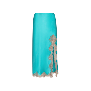 The Tico Silk Lace Skirt features turquoise blue silk in a knee-length, fitted silhouette, accented with an asymmetrical beige eyelash lace trim at the hem and a vertical lace detail on one side. Its smooth texture completes the elegant design.