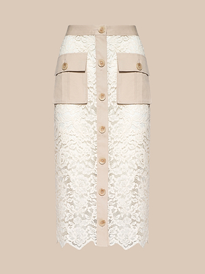 The Shae Skirt features beige and white floral lace, a front button closure, large beige cargo pockets, and a scalloped lace hem, shown against a plain beige background.