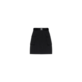 The Norene Nylon Mini Skirt is a black, high-waisted cargo mini skirt featuring large front cargo pockets and a matching belt with a rectangular buckle. Crafted from water-repellent nylon, it is shown against a plain white background.