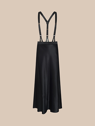 The Vespera Suspender Maxi Skirt, crafted from black satin and featuring attached adjustable suspenders, is displayed on a beige background. With its smooth, shiny texture and A-line silhouette inspired by the elegant Vespera collection, this piece offers timeless sophistication.