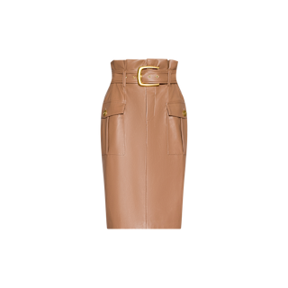 The Kaelis Vegan Leather Skirt is a high-waisted tan pencil skirt featuring a subtle paperbag waist, two front flap pockets with button details, and a wide matching belt with a gold buckle. This classic midi silhouette is showcased against a plain white background for a modern touch.