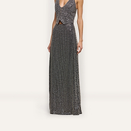A person wearing a L’AGENCE sleeveless, deep V-neck top and a hand-beaded Zeta Beaded Maxi Skirt, both covered in silver beading.