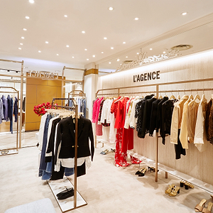 Fashion store interior with clothing racks displaying various garments.