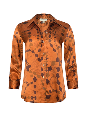 The Dani Silk Blouse is a shiny burnt orange button-up with a collar and long sleeves, featuring brown playing card suits, geometric shapes, and chessboard patterns in luxurious silk charmeuse.