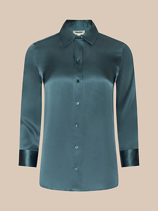 A teal Dani Silk Blouse featuring long sleeves, a classic collar, and shiny cuffs, displayed on a beige background.
