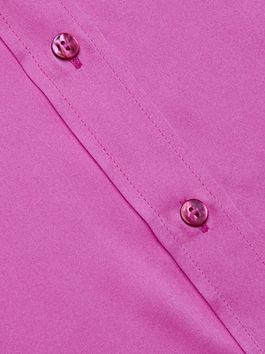 Close-up of the Dani Silk Blouse in fuchsia, featuring two pink buttons and visible stitching.