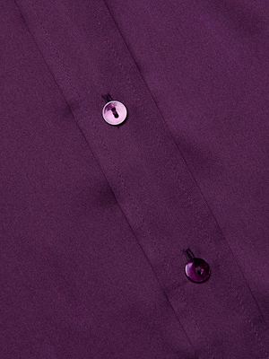 Close-up of the Dani Silk Blouse by L'AGENCE, highlighting two purple buttons sewn onto the silk charmeuse fabric along the front placket.