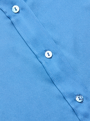 Close-up of the Dani Silk Blouse in regatta blue, featuring a row of white buttons on the placket with smooth silk fabric and precise stitching on display.