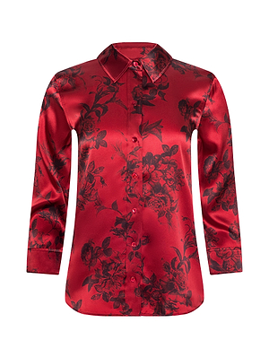 The Dani Silk Blouse by L'AGENCE is a vibrant red, long-sleeved satin shirt with a subtle black floral print and classic collar—an elegant button-up essential for any woman's wardrobe.