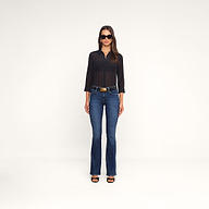 A woman wearing sunglasses, the Dani Cotton-Silk Blouse—a sheer black button-down with 3/4 sleeves—paired with blue jeans, a belt featuring a large buckle, and black open-toe heels stands facing forward against a plain white background.
