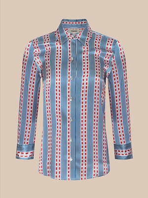 The Dani Silk Blouse is a long-sleeve, button-down top with a collar, featuring vertical blue stripes and red dots on white silk charmeuse, shown against a plain beige background.