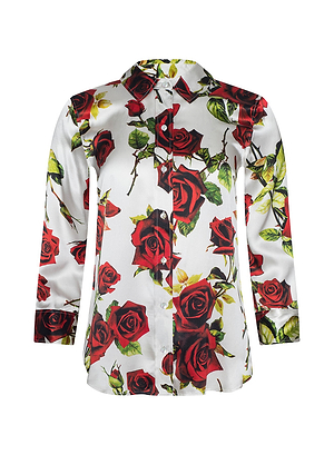 The Dani Silk Blouse features a white background with bold red rose prints and green leaves in a classic long-sleeve button-down style.
