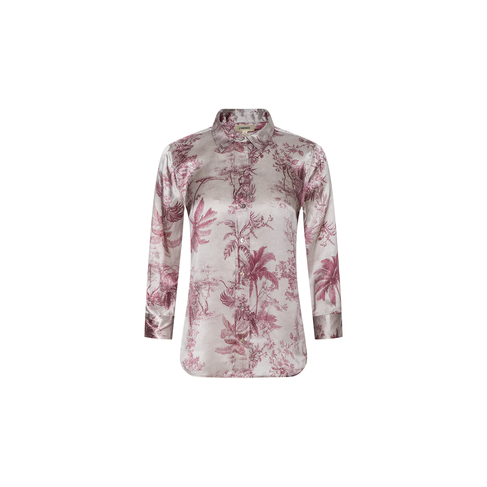 The Dani Silk Blouse is a long-sleeve, collared top featuring a pink and white jungle toile print, crafted from silk with a button-down front and a curved hem, shown against a plain white background.