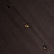 Close-up of the Tyler Silk Blouse in dark brown silk charmeuse, featuring diagonal stitching and three round, shiny buttons evenly spaced along the seam.