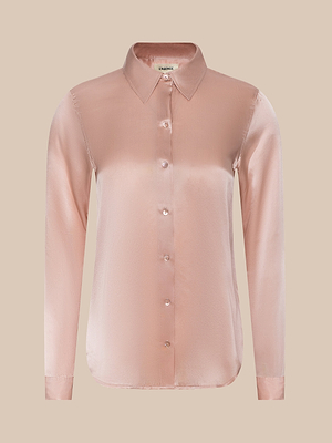 The Tyler Silk Blouse from LAGENCE is a light pink, long-sleeve satin button-down with a collar, shown on a plain beige background.