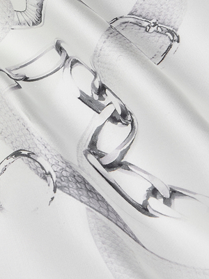 Close-up of Lexi Satin Camisole’s bias-cut fabric, showcasing a subtle gray print of interlocking metallic chains and buckles, with soft folds adding gentle shadows. Perfect for a chic look with its adjustable straps.