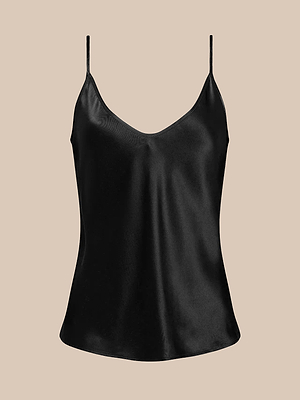 The Lexi Silk Camisole features adjustable spaghetti straps, a V-neckline, and a glossy black silk charmeuse finish, showcased against a beige background.