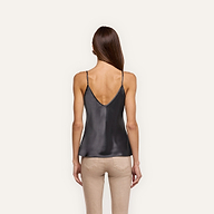 Back view of a person wearing a charcoal gray Lexi Silk Camisole in a silk charmeuse bias-cut style paired with tan pants.