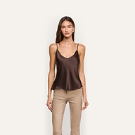 A person wearing a bias-cut dark brown silk charmeuse Lexi Silk Camisole and tan pants.