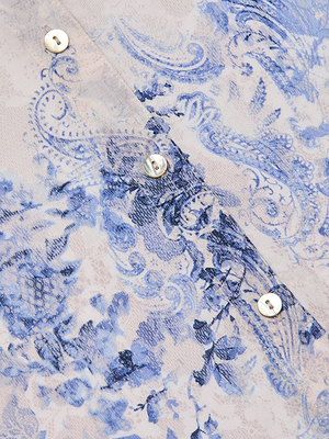 Close-up of the Camille Blouse, a three-quarter sleeve top in viscose twill with an ivory and blue lace floral-paisley print, finished with three white buttons on the placket.