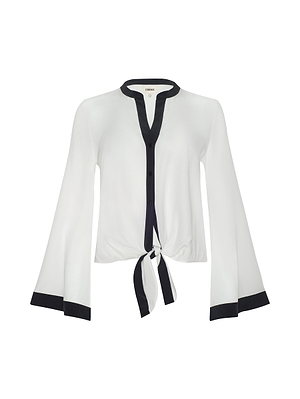 The Charlize Silk Blouse is an ivory top with black trim on the cuffs and neckline, a button-down front, and a chic silk tie-front at the waist.