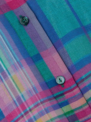 Close-up of the Cosette Plaid Shirt, showcasing colorful blue, green, pink, and purple intersecting lines and two dark green buttons on soft viscose chiffon fabric.