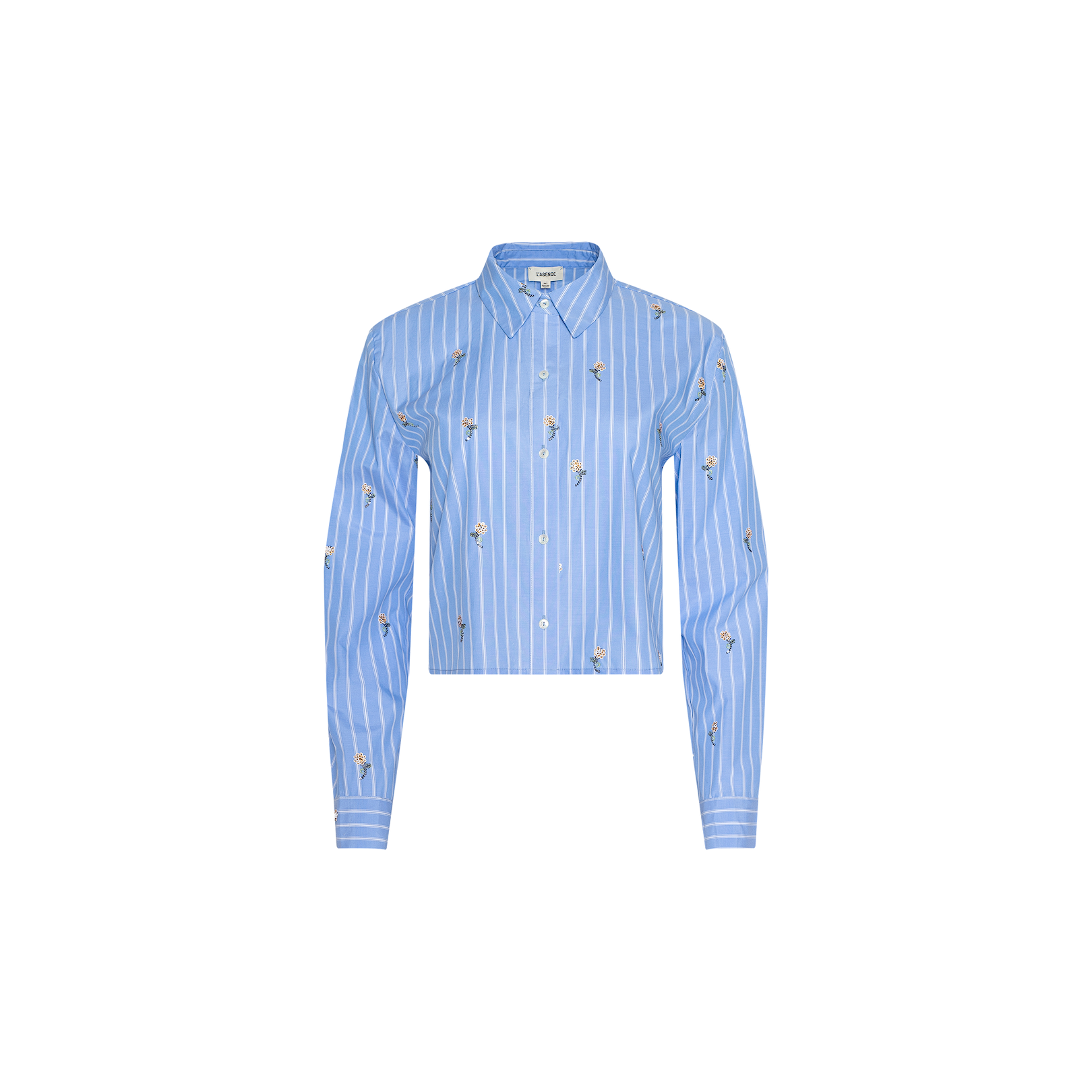 The Cosette Sequined Shirt is a blue, long-sleeved, striped poplin shirt featuring white vertical stripes, small embroidered designs, and a stylish cropped high-low hem, displayed on a plain white background.