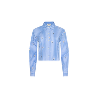 The Cosette Sequined Shirt is a blue, long-sleeve striped poplin shirt with white vertical stripes, small embroidered designs, and a cropped high-low hem, shown against a white background.