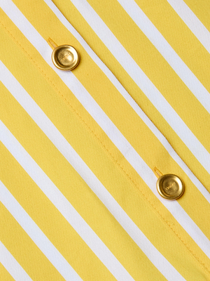 Close-up of the Cosette Shirt’s yellow and white striped organic cotton-blend poplin fabric, featuring two gold buttons sewn along a diagonal seam, highlighting the refined details of this classic tailored piece.