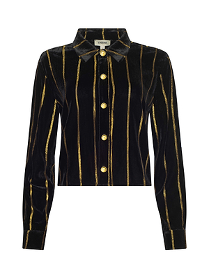 The Cosette Velvet Shirt is a black long-sleeve velvet top with vertical gold stripes, gold front buttons, and a classic collar. Its cropped high-low hem and structured design give this shirt a modern take on timeless style.