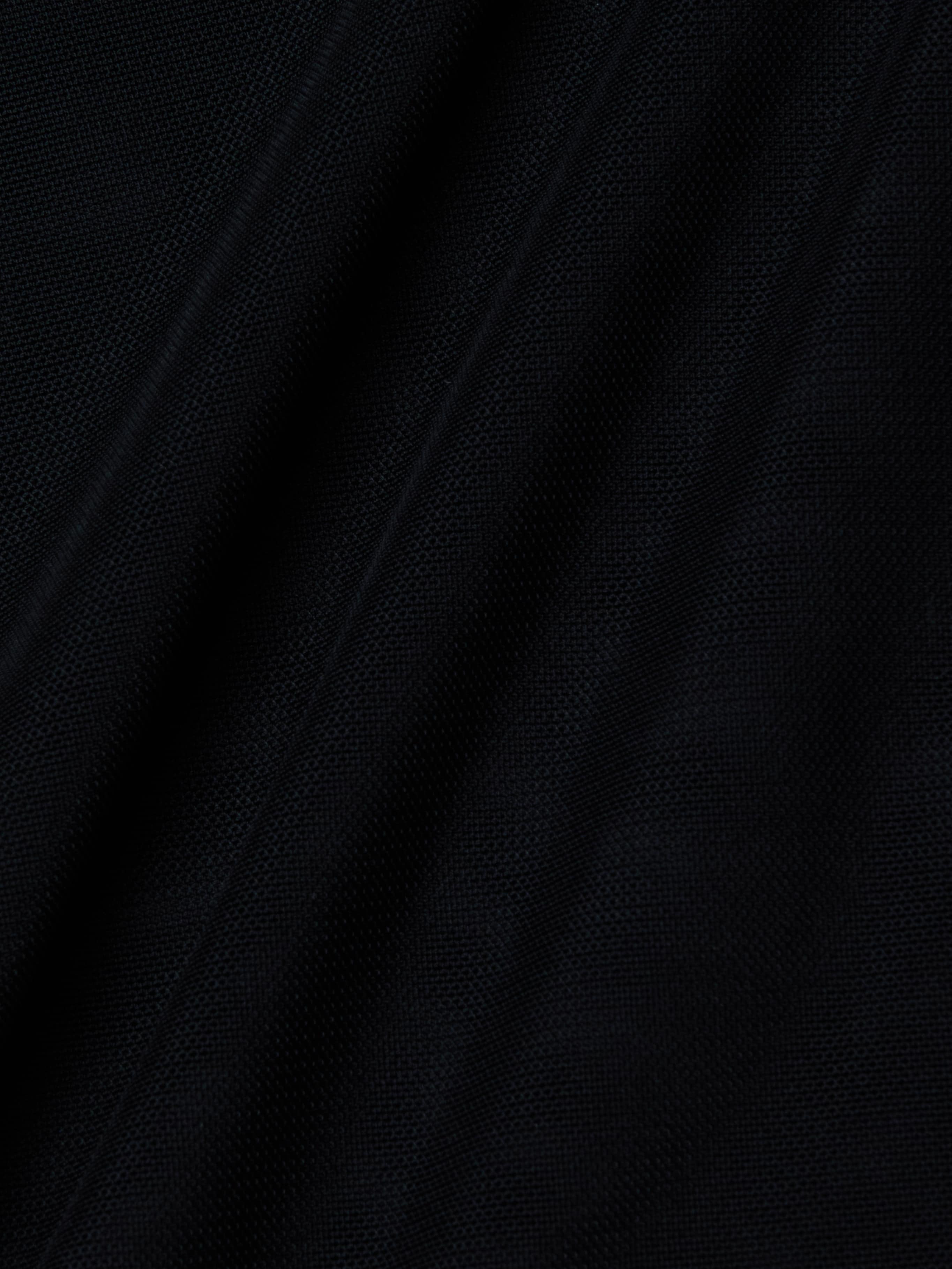 Close-up of the Trista Bodysuit’s black mesh fabric, showcasing its visible weave texture and diagonal folds that create subtle shadows and highlights across the surface.