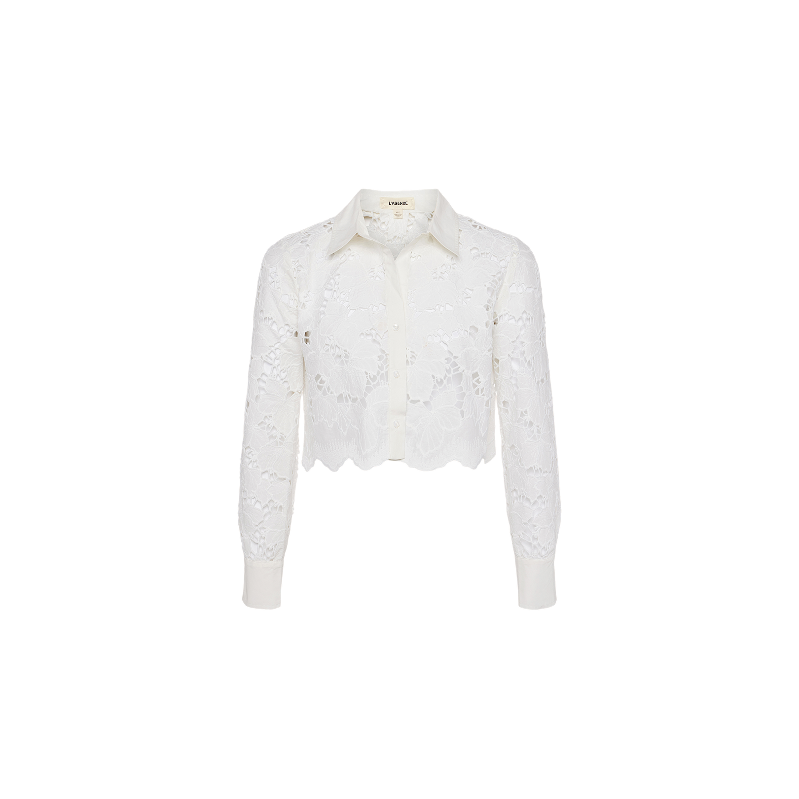 Seychelle Cropped Eyelet Blouse—white long-sleeve cropped blouse featuring visible floral eyelet lace patterns, a scalloped hem, button-down front, and classic collar. Displayed on a plain white background.