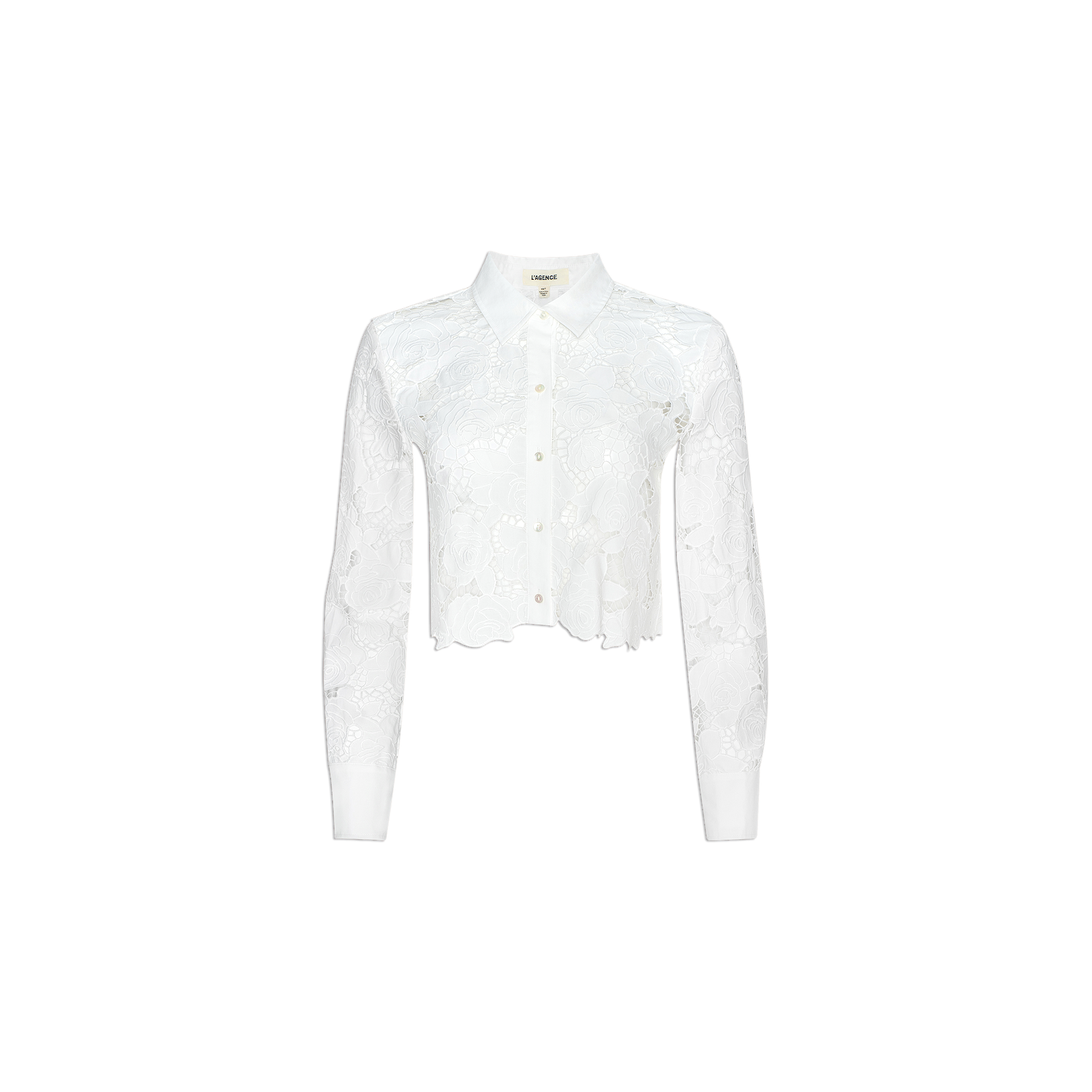The Seychelle Cropped Eyelet Blouse is a white long-sleeve top featuring a floral lace pattern and a cropped cut hem, displayed on a plain light background.